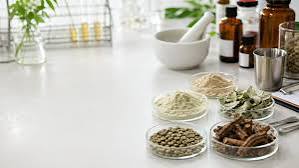 Indian herbal ingredient samples with quality documentation on a sourcing desk