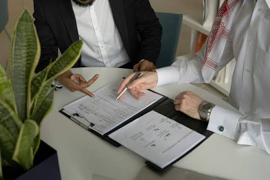 Professional reviewing documents and conducting supplier evaluation