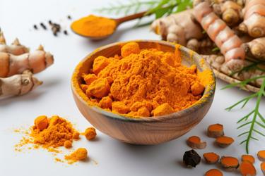 Six bowls of turmeric powder and fingers from different Indian growing regions arranged for a side-by-side origin comparison