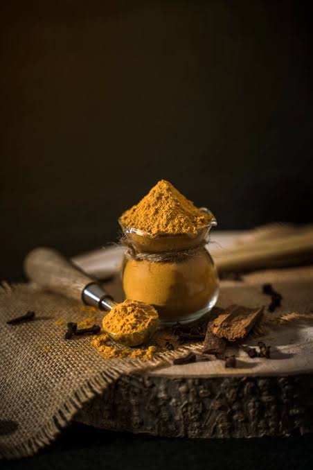 Lakadong turmeric powder beside Malaysian and Indonesian halal certification symbols representing JAKIM certification and regional market positioning