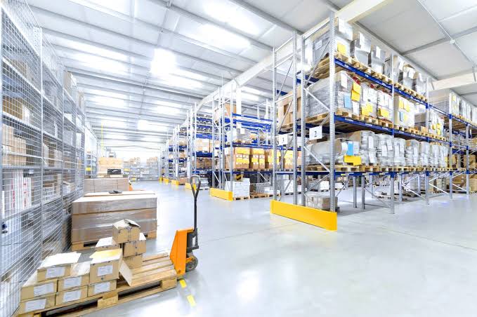 Sealed bags of Lakadong turmeric powder in a climate-controlled warehouse storage area after import