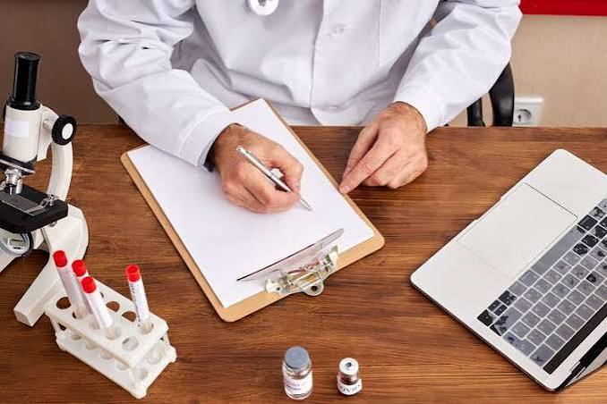Quality inspector reviewing certification documents at an Indian Ayurvedic ingredient manufacturing facility