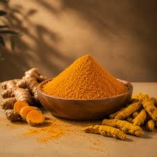 Turmeric roots and curcumin powder on a wooden surface