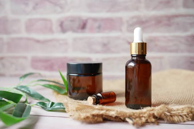 Three essential oil bottles on white surface